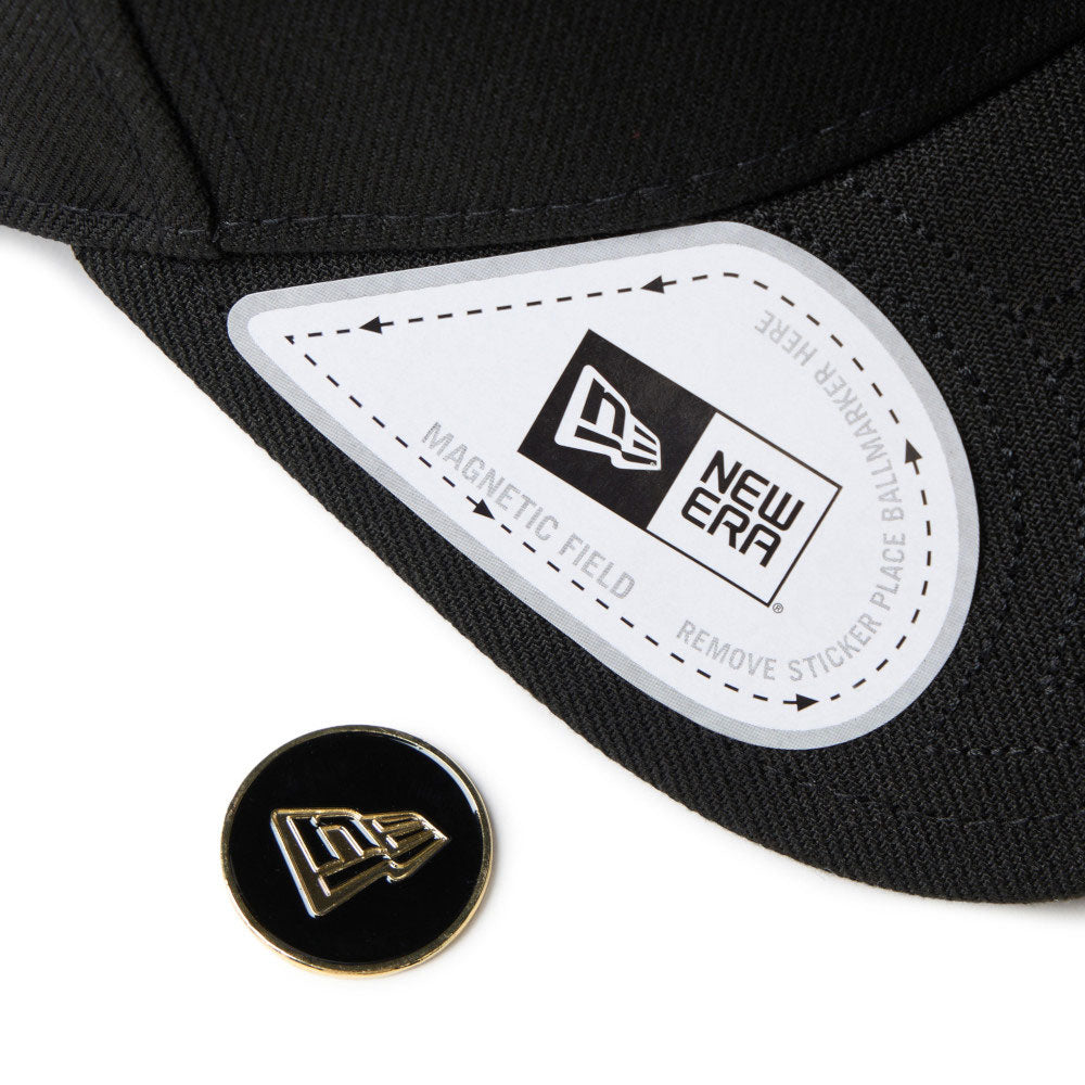 new era wordmark golf black 9forty velcro strap adjustable cap close-up front brim view with magnetic field sticker label