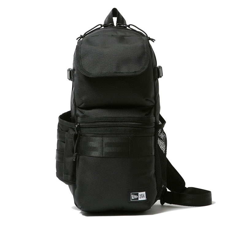 Front view of black New Era sling body bag with flap pocket, zip compartment, webbed strap, buckles, and logo patch.