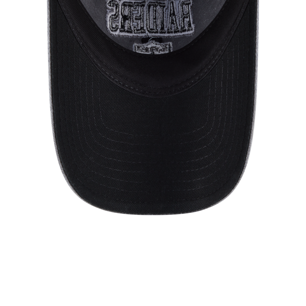 Close-up of the front of a black baseball cap with a gray embroidered patch on the crown, isolated on a white background.