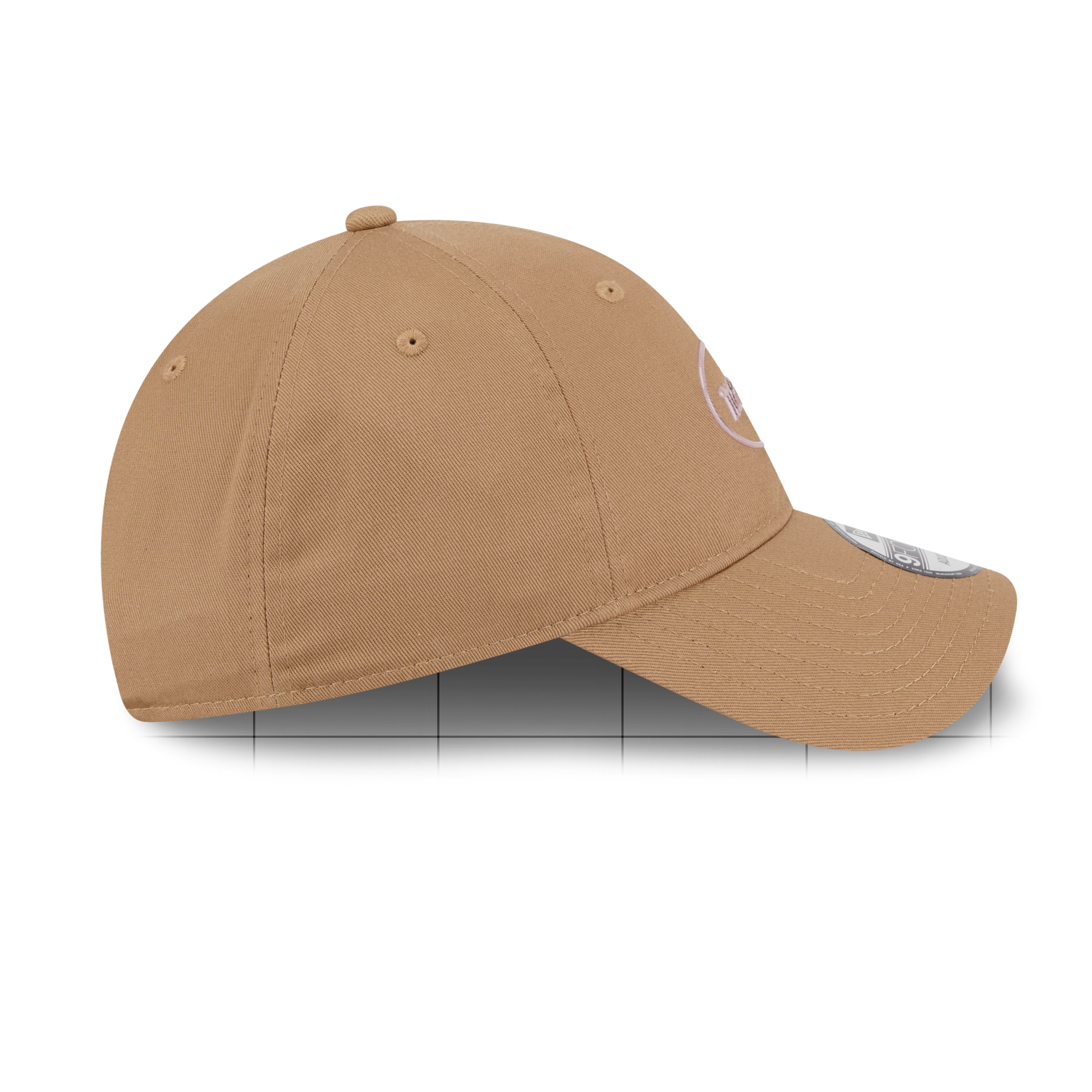 A classic six-panel baseball cap in a warm tan or camel color, shown from a side profile view against a white background.