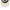 Close-up of the front of a trucker-style cap showing a curved cream-colored brim, black mesh back panels, and black embroidered trim.