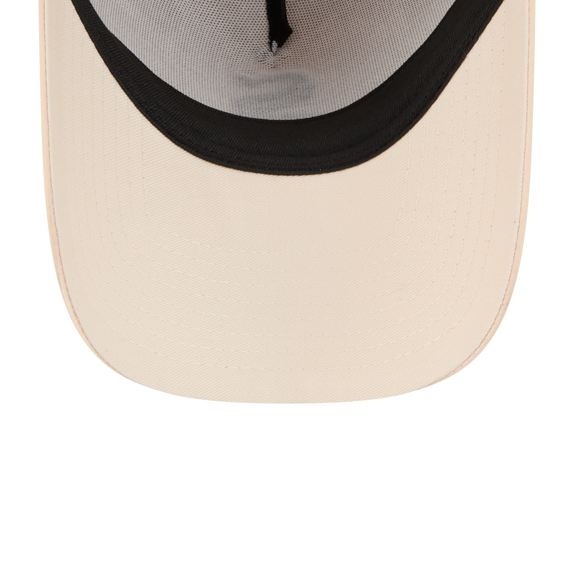 Close-up of the front of a trucker-style cap showing a curved cream-colored brim, black mesh back panels, and black embroidered trim.