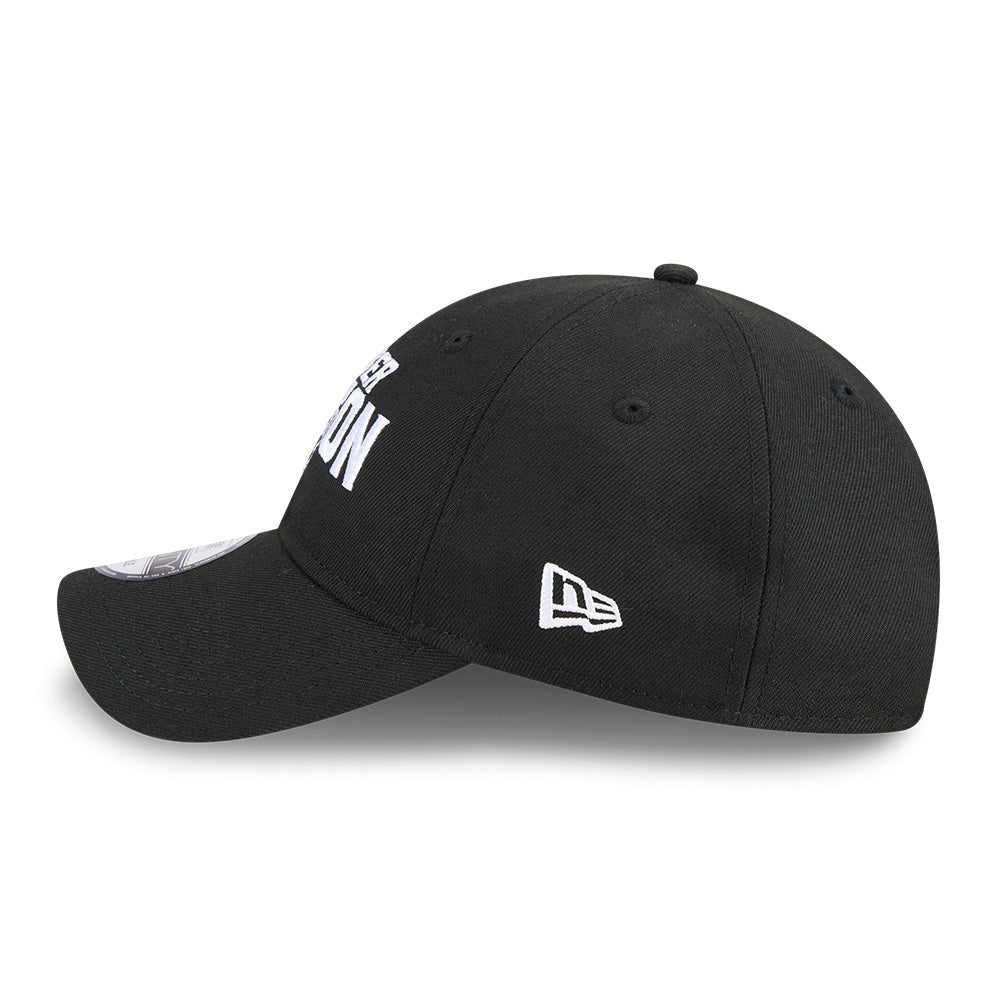A black baseball cap with white embroidered text on the front and a white New Era logo on the side, shown against a plain white background.