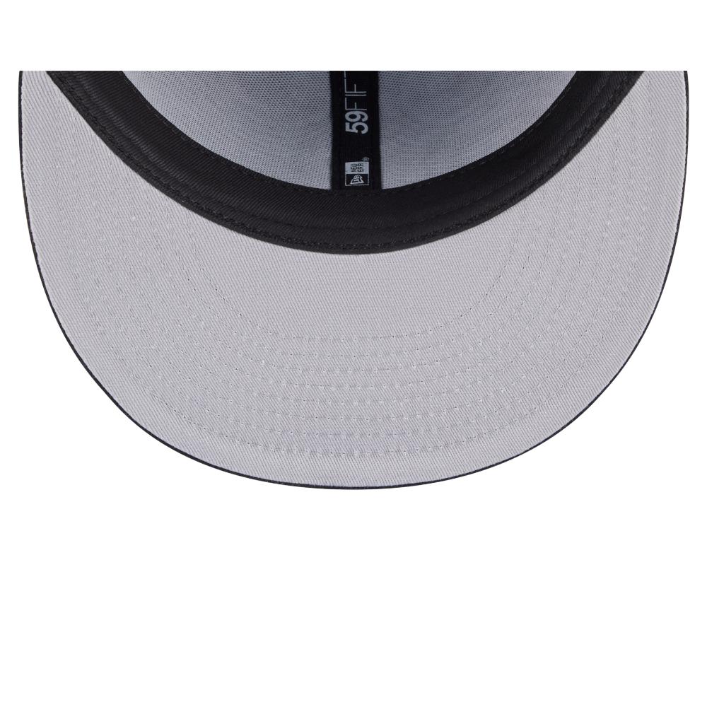Close-up of the inside of a baseball cap showing a light gray brim, black curved brim edge, and a black size/branding label in the center.