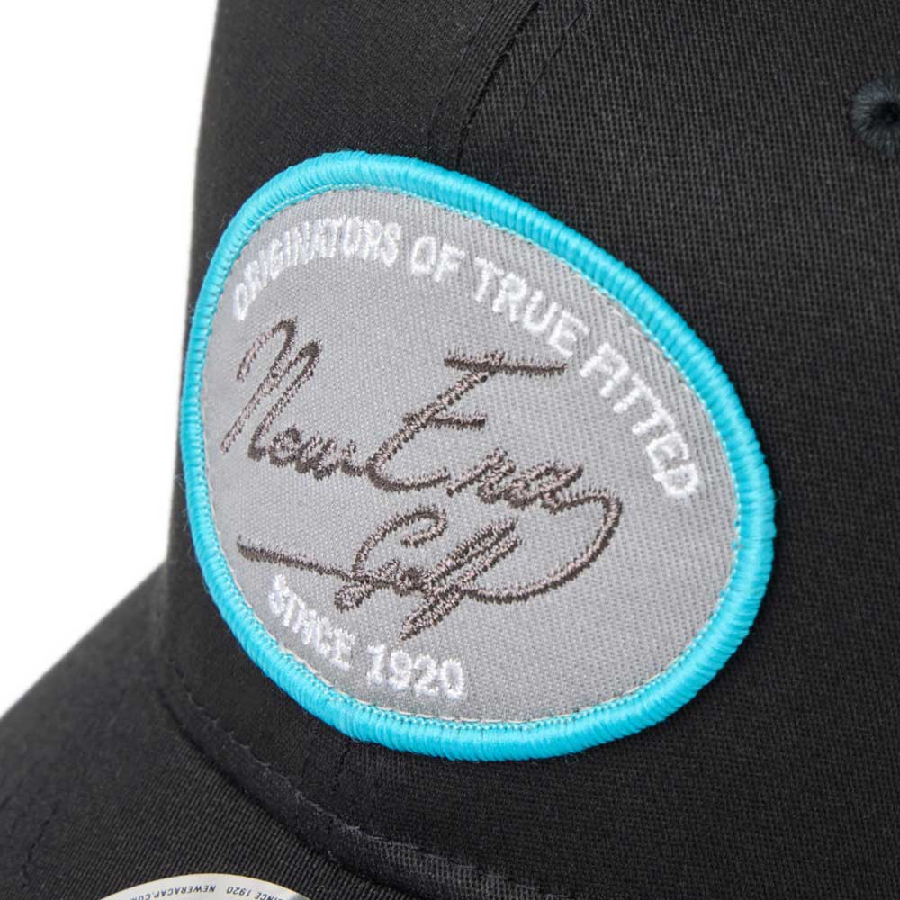 new era script oval patch black golf 9seventy stretch snapback cap with a gray patch featuring text and a signature, on a white background