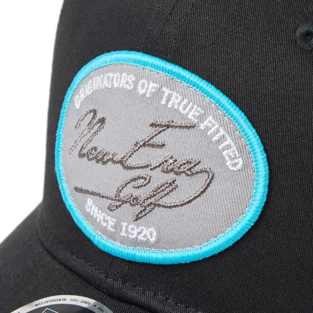 new era script oval patch black golf 9fifty stretch snapback cap side cap with a gray patch close-up view