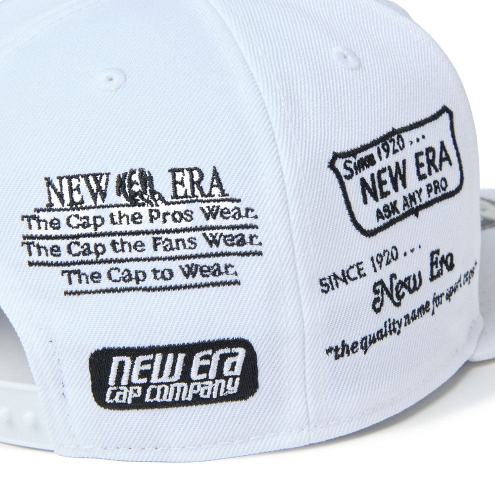 A white new era wordmark golf ne archive white 9fifty snapback cap with black printed graphics and text on the other side