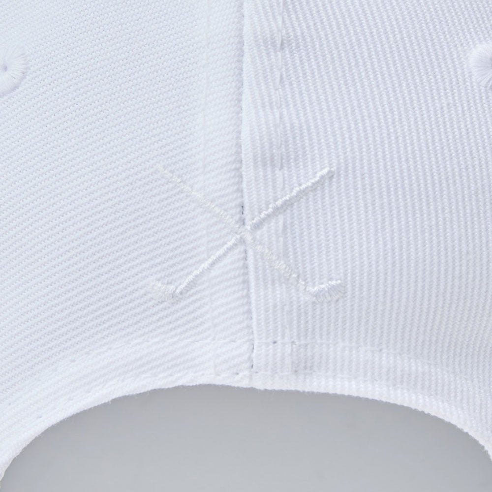 Close-up of new era wordmark golf stencil logo white 9forty adjustable cap with a logo on a light gray background