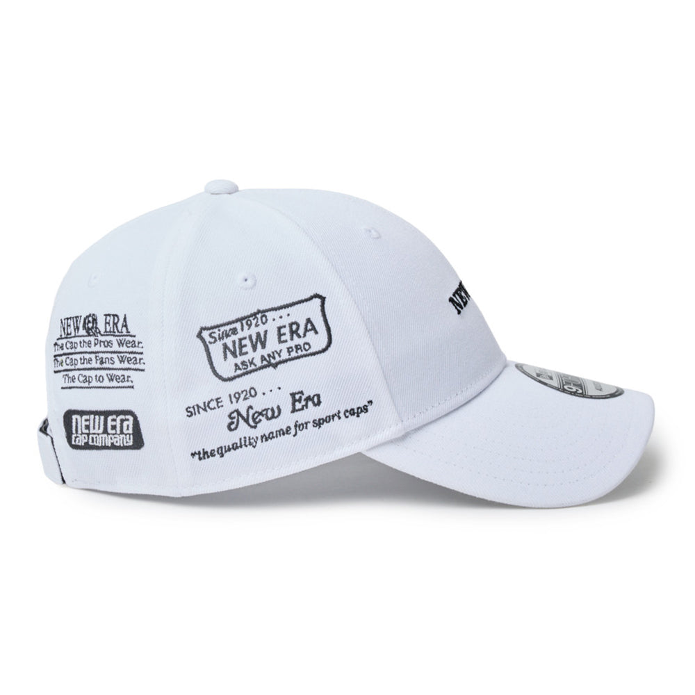 A white new era wordmark golf ne archive white 9forty velcro strap adjustable baseball cap with black embroidered text and logos on the front panels and brim, shown on a clean white background.