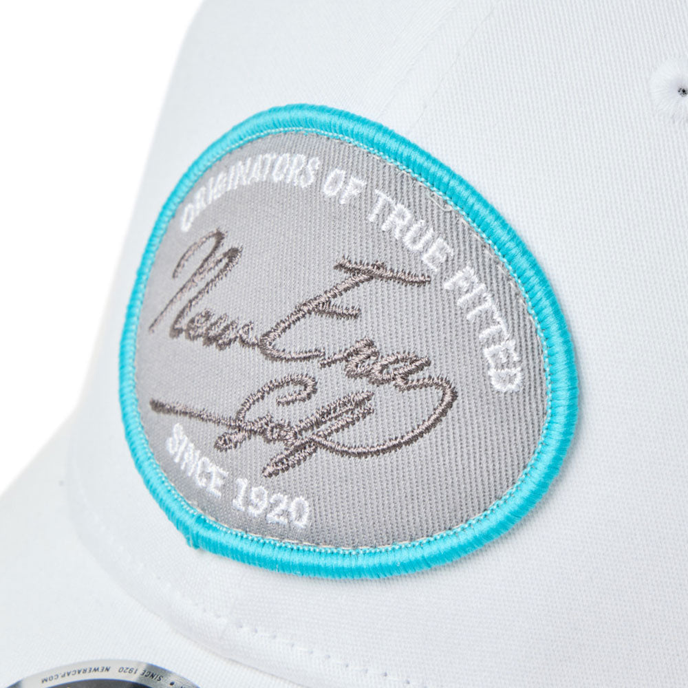 Close-up of a new era script oval patch white golf 9forty stretch snapback cap