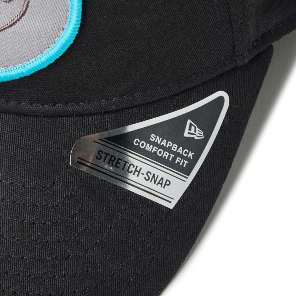 new era script oval patch black golf 9forty stretch snapback cap side with a New Era Stretch-Snap label