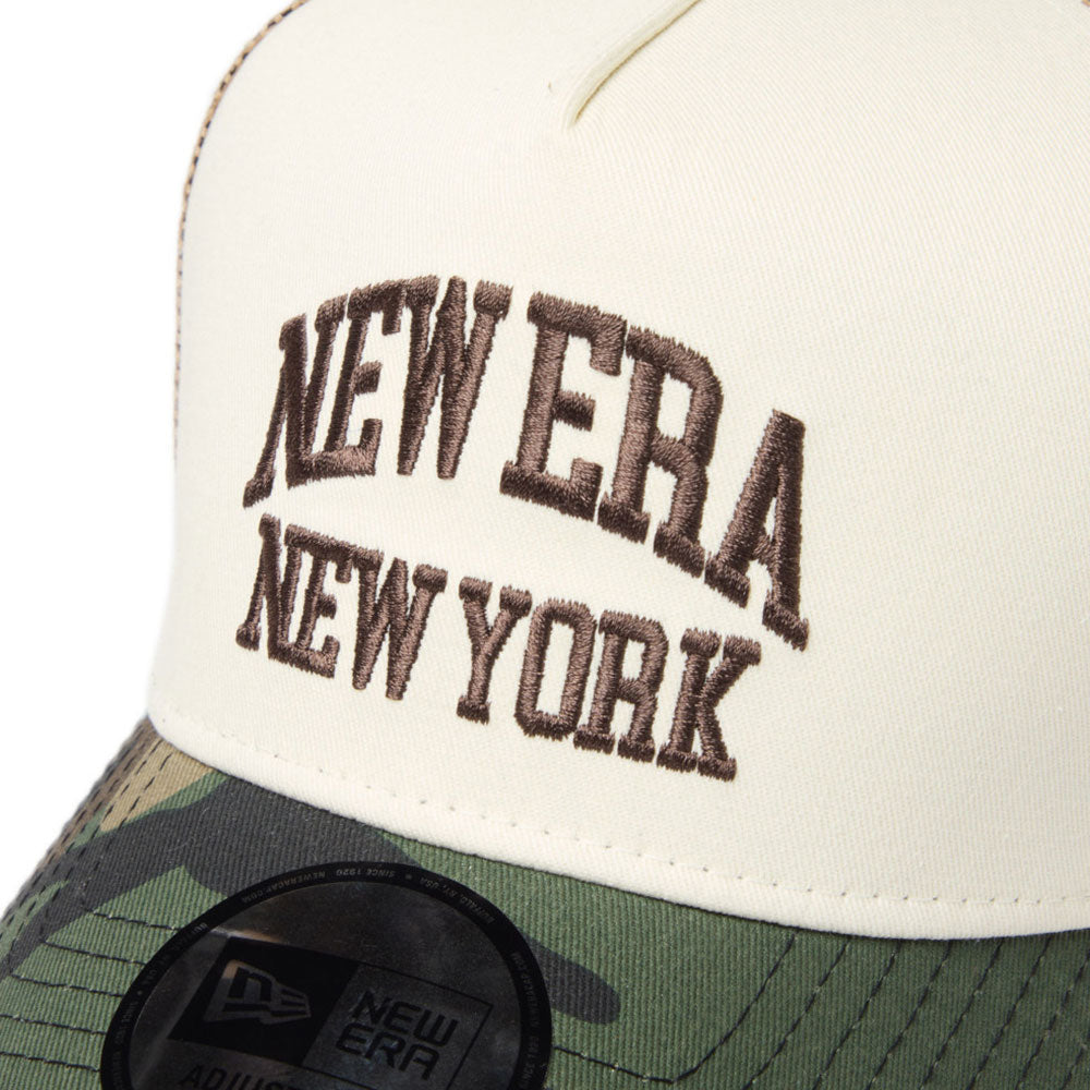 Close-up of new era wordmark ne collog cream brown 9forty a frame trucker cap with 'New Era New York' embroidered text