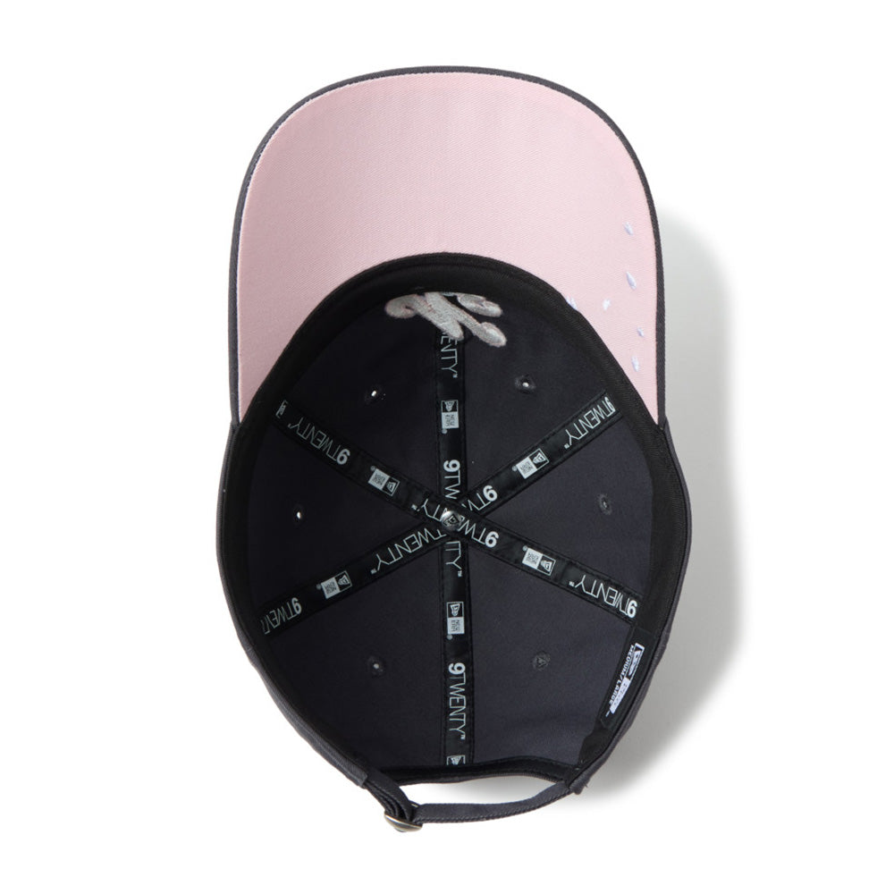 A black baseball cap shown from a top-down view, featuring a light pink inner brim and black adjustable straps with white '9YANG' branding.