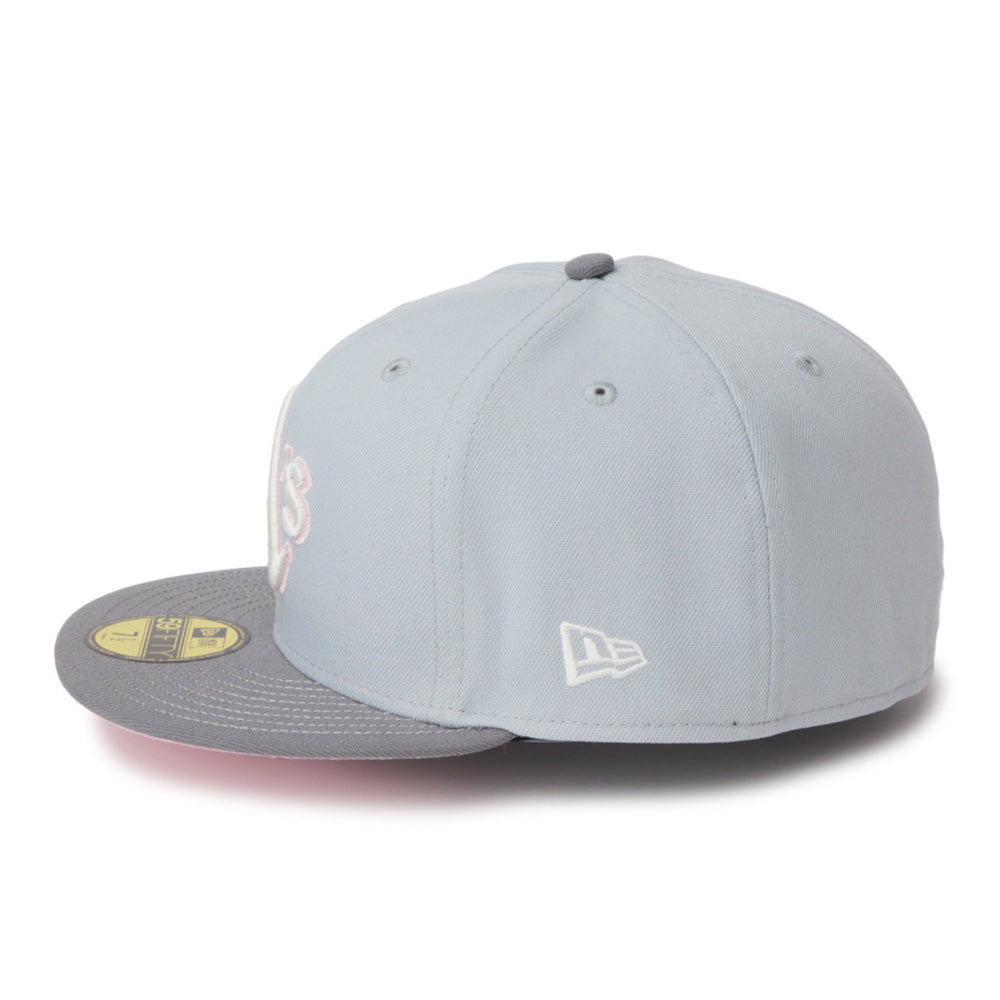 A light blue-gray New Era fitted cap with a gray flat brim, featuring a white embroidered New Era logo on the side and a gold size sticker on the brim.