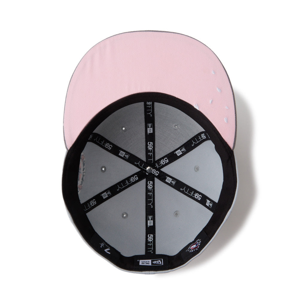 Pink and gray cap with brand logo on a white background