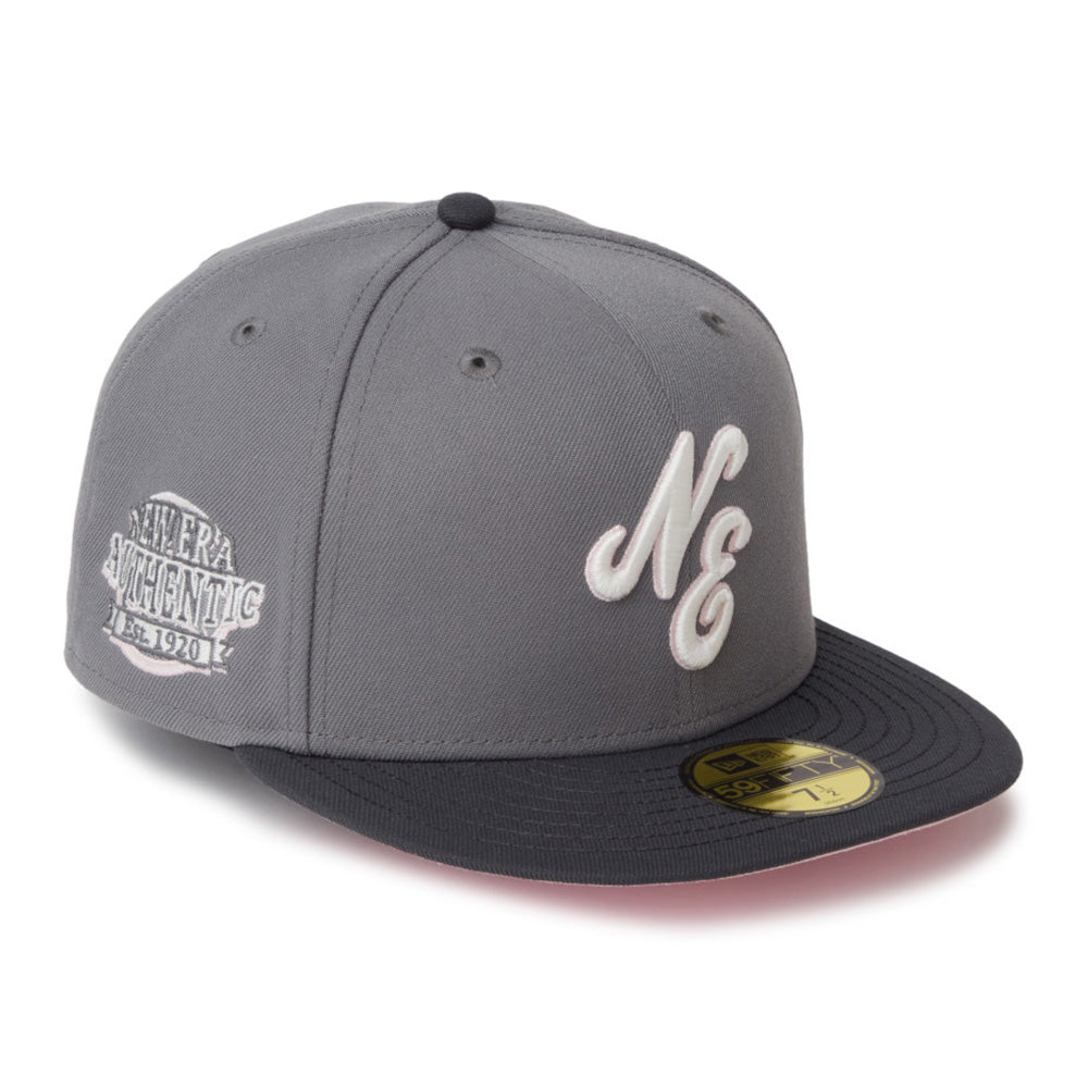 A gray and black baseball cap featuring a white embroidered 'N' and 'E' logo on the front and a silver 'SILVERA AUTHENTIC EST. 1981' patch on the side, with a gold New Era 501 sticker on the brim.
