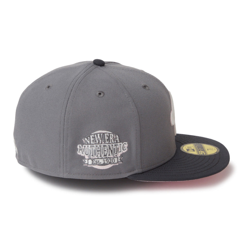 A gray and black New Era 59FIFTY fitted cap featuring a white embroidered 'New Era Authentic Est. 2011' patch on the front and a gold sticker on the brim, set against a plain white background.
