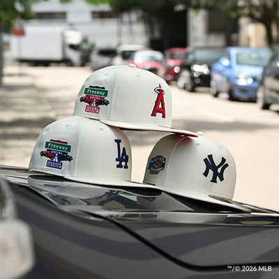 Three white caps with different team logos and graphic embroidered designs.