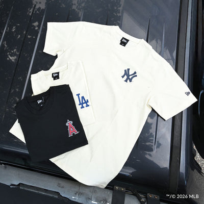 two folded t-shirts and 1 unfolded t-shirt with different team logos