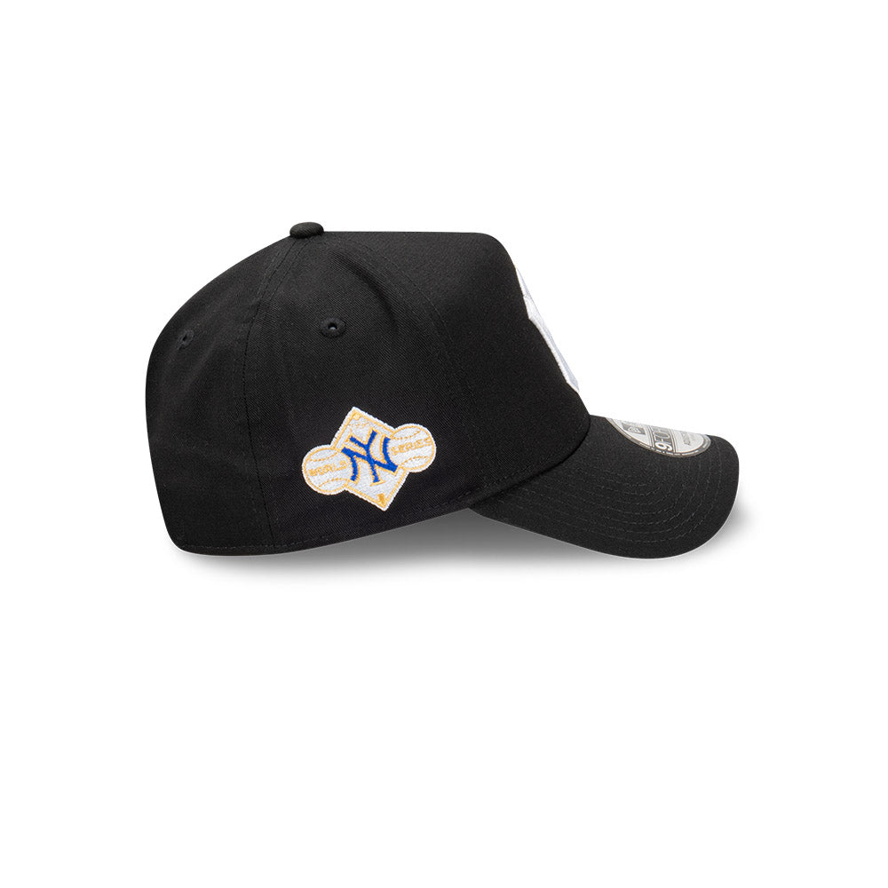 A black baseball cap featuring a baseball-shaped patch with the New York Yankees logo on the front and a silver New Era 9FIFTY sticker on the brim, set against a plain white background.